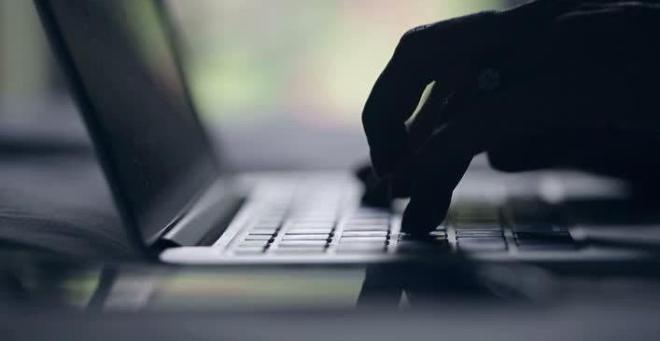 hand typing on laptop